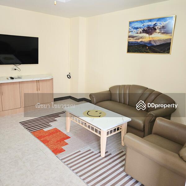One bedroom: Living area with large TV.