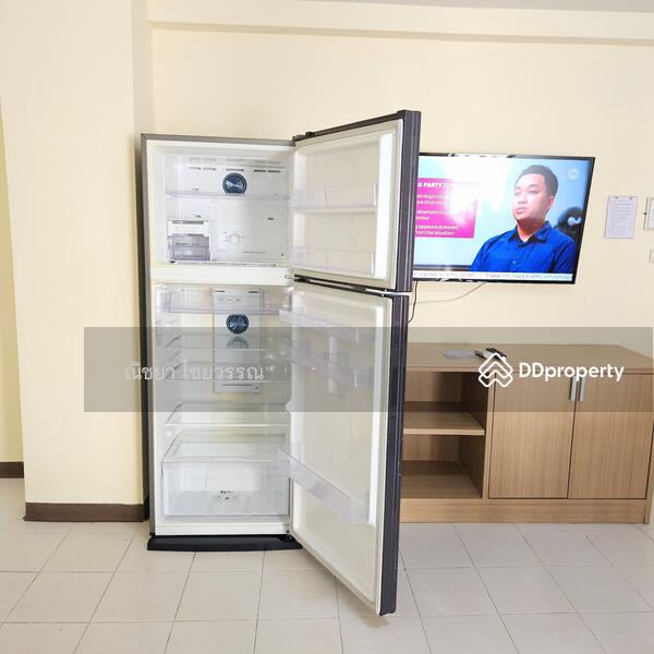 Large refrigerator with freezer on top.