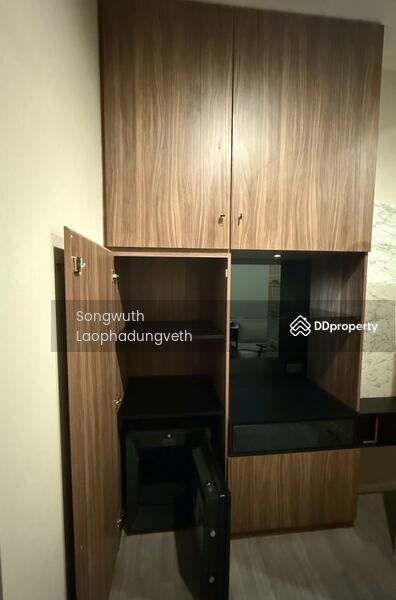 A custom-built storage cabinet designed with a built-in secure safe at the bottom.